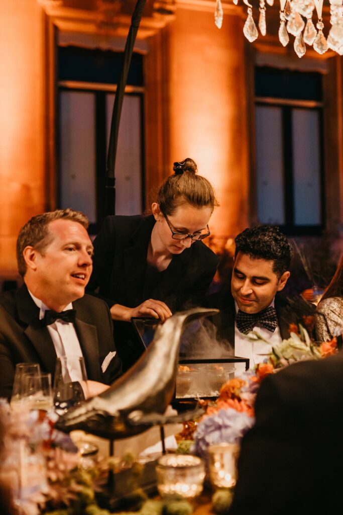 Guests eating dinner, whale prop, box with smoke