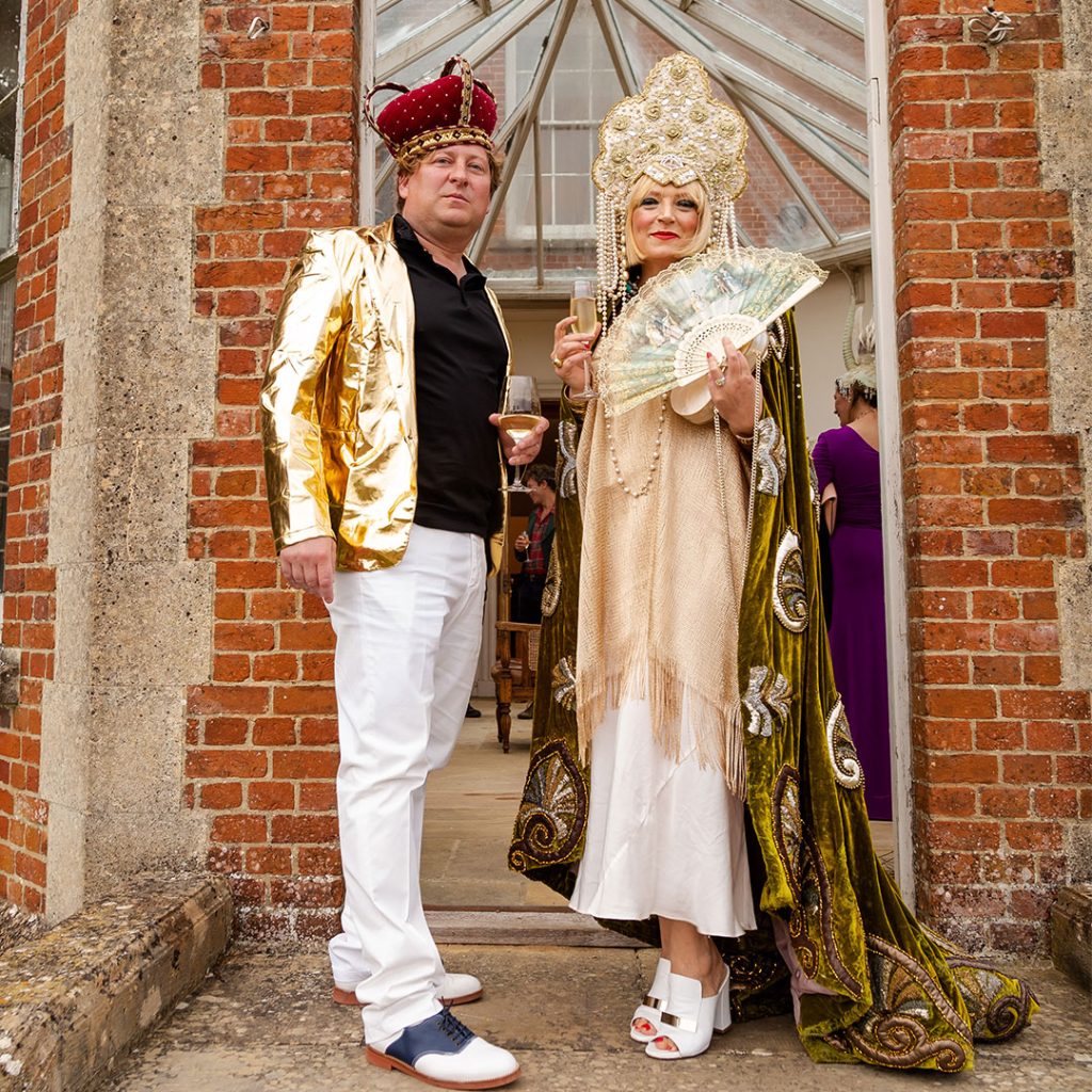 A man and woman dressed in regal fancy dress.