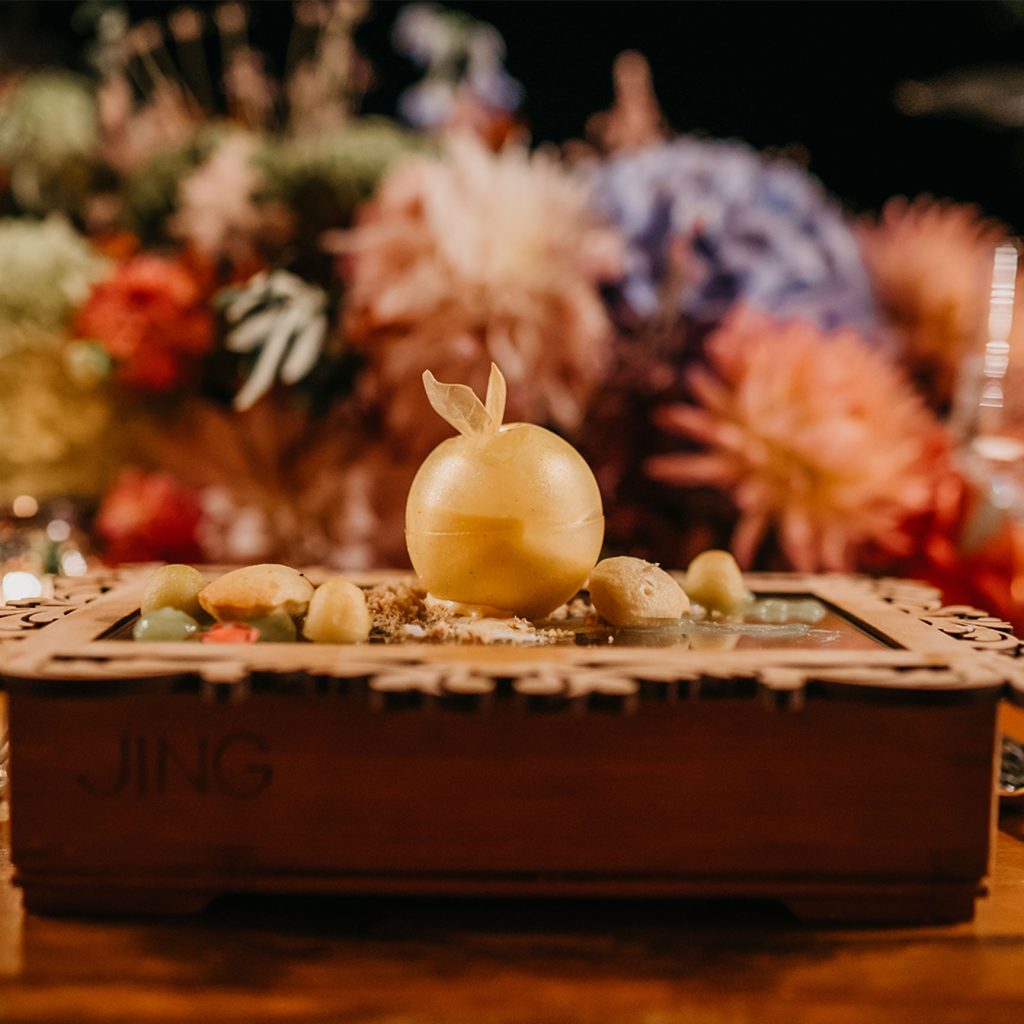 Apple Brûlee Dessert served on a wooden box with a wooden frame.
