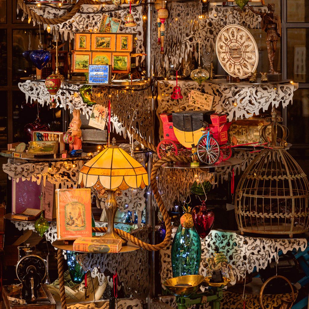 Antiques placed on metal shelves on a steel Christmas Tree