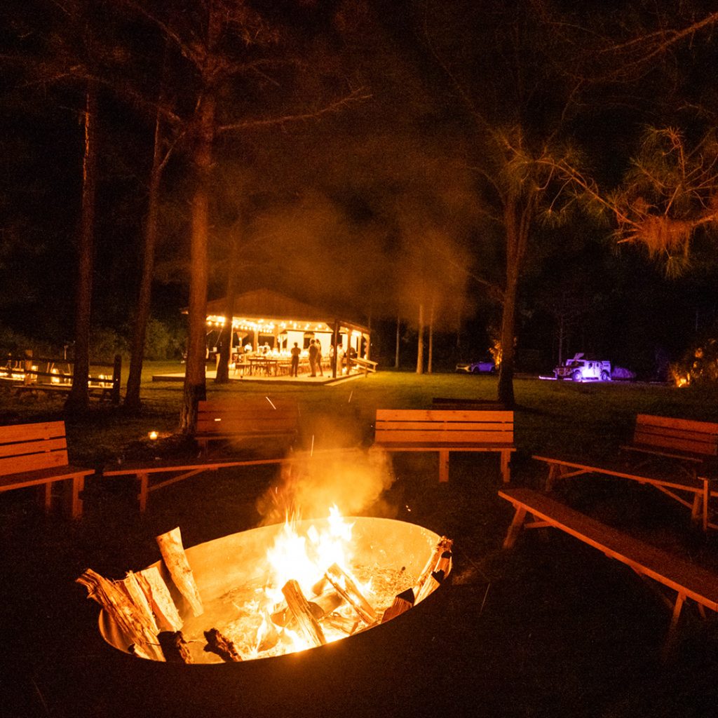 A fire pit alight with logs ablaze.