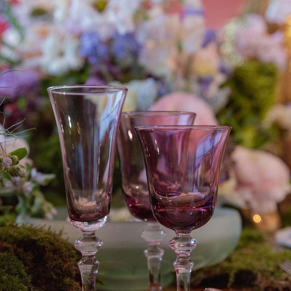 Three plum coloured wine glasses