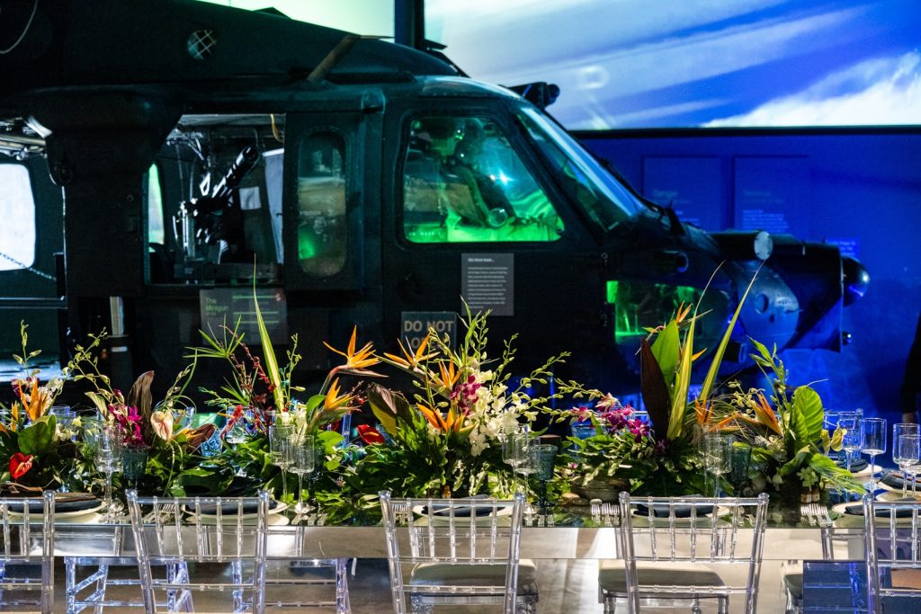 A Black Hawk Helicopter and a dining setup with tropical flowers. Immersive event agency.