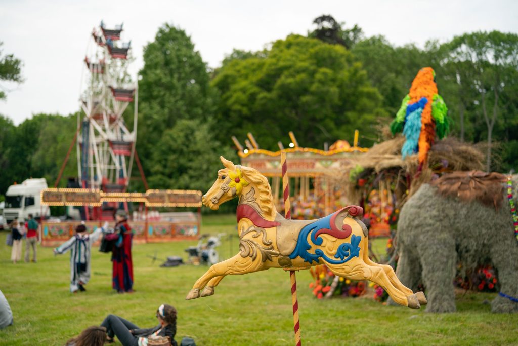 A freestanding carousel horse and fairground ferris wheel