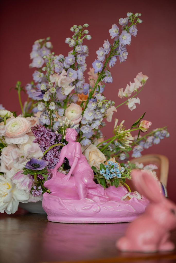 Pink antiques and Sylvac Bunny in front of flowers