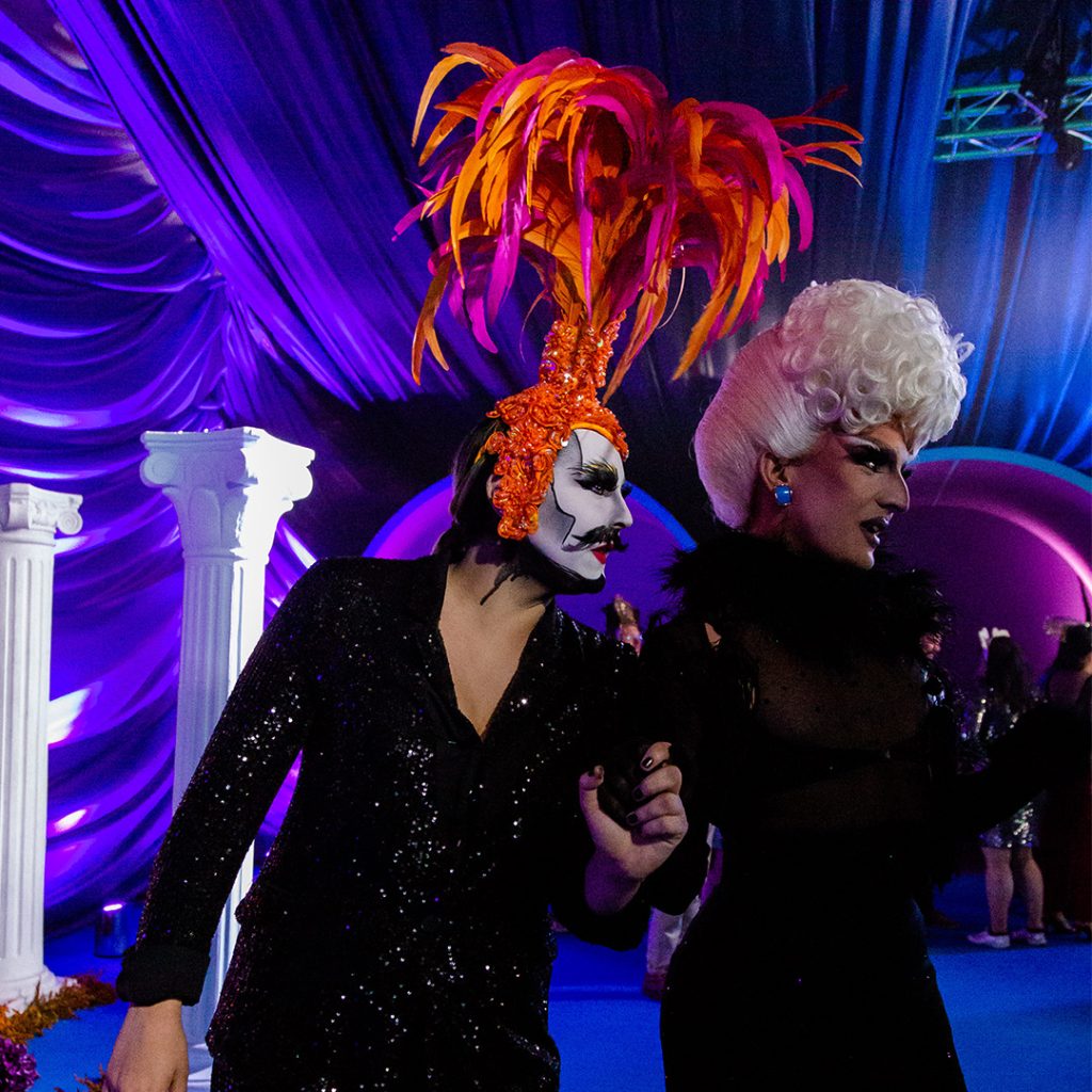 Drag performers with extravagant wigs.