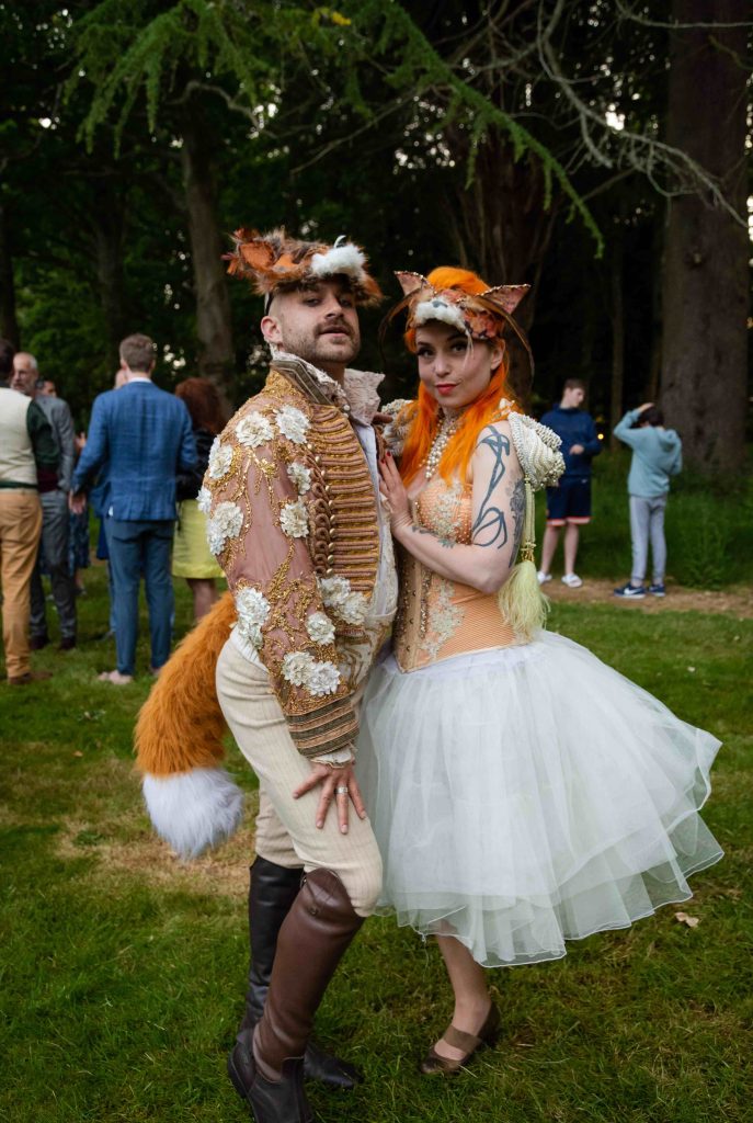 Two performers dressed like foxes