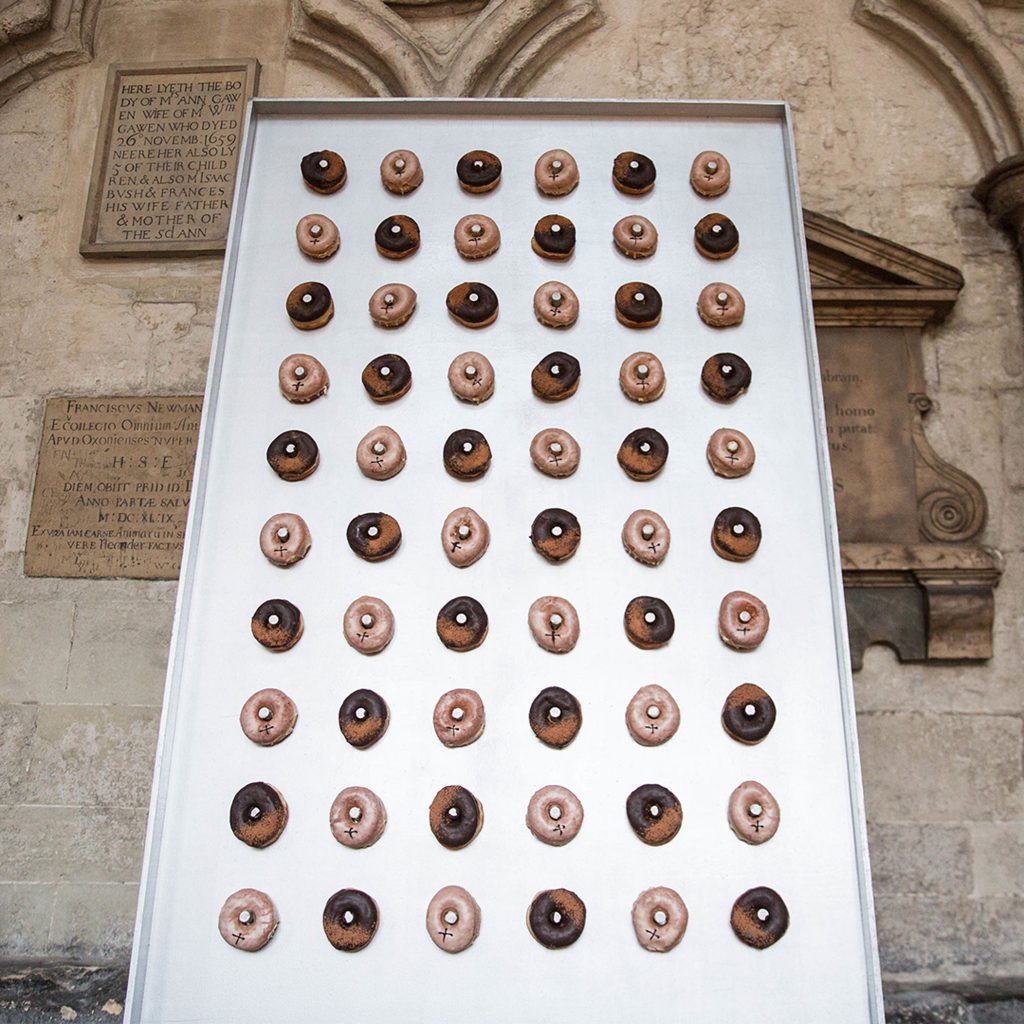 Doughnuts hung on a wall made of metal