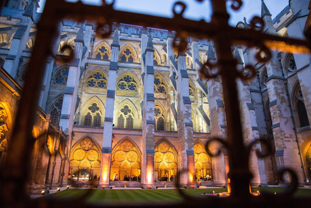 The facade of Westminster Abbey lit in amber light.