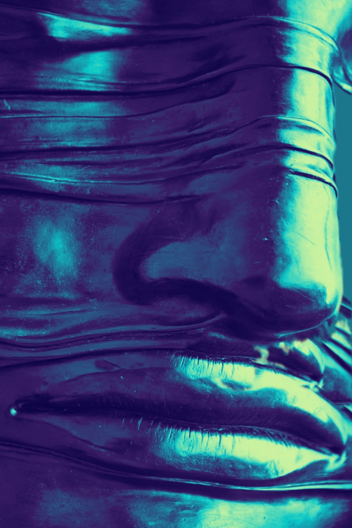 A Roman face coloured in blue and green.